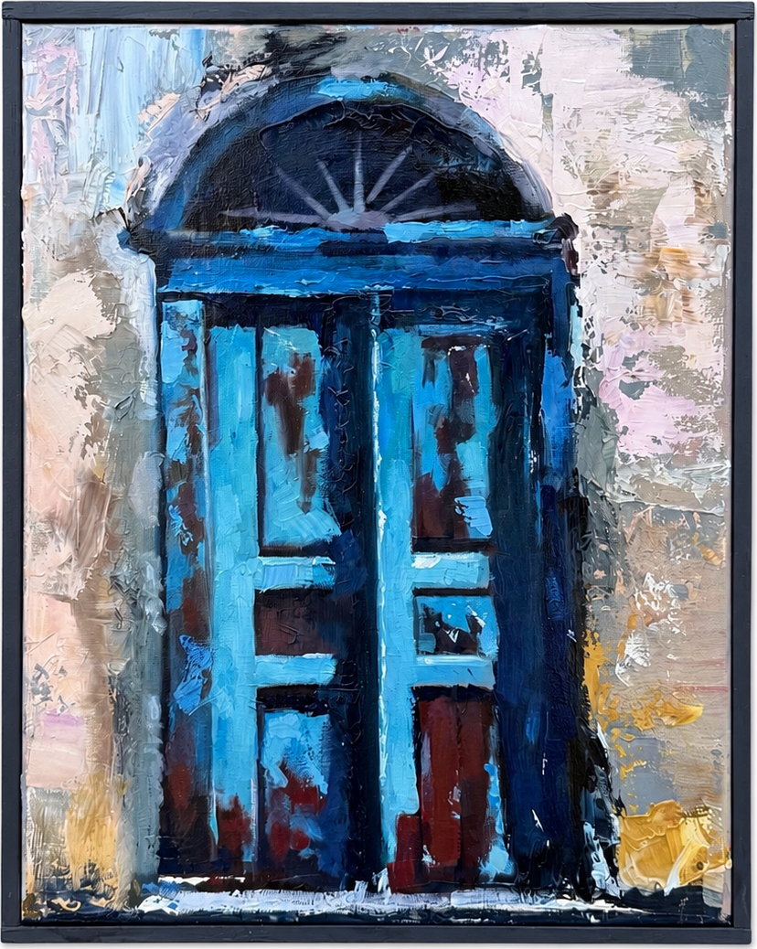 A blue arched door set into a pale textured wall